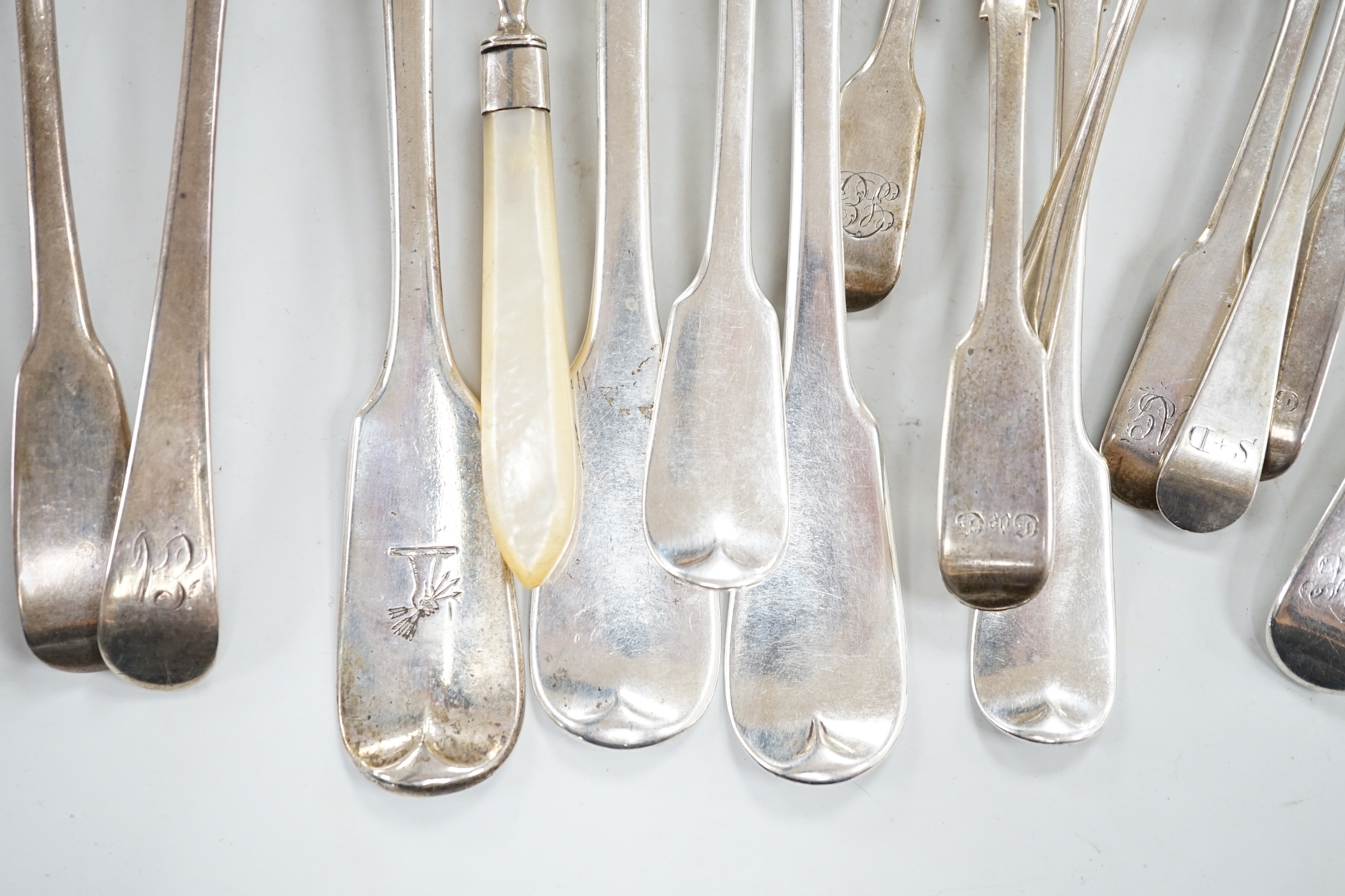 A George III silver Old English feather edge dessert spoon, London, 1775 and a small quantity of assorted mainly 19th century silver flatware including an Irish table fork, various patterns, makers and dates, 18.5oz.